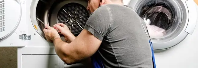 Dryer repair technician fixing a clothes dryer drum in Allentown, PA