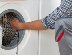Dryer repair technician diagnosing and servicing a clothes dryer in Allentown, PA