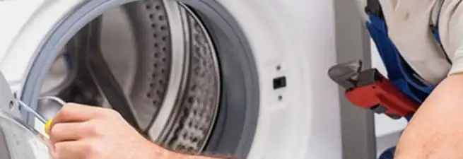 Appliance technician repairing a clothes dryer drum and internal parts in Allentown, PA