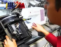 Vacuum repair technician servicing internal components on a workbench in Allentown, PA