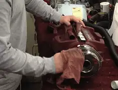Vacuum repair technician cleaning and servicing a vacuum motor in Allentown, PA