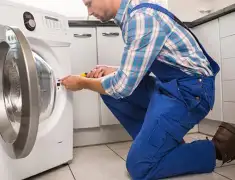 Washing machine repair technician servicing a front-load washer in Allentown, PA